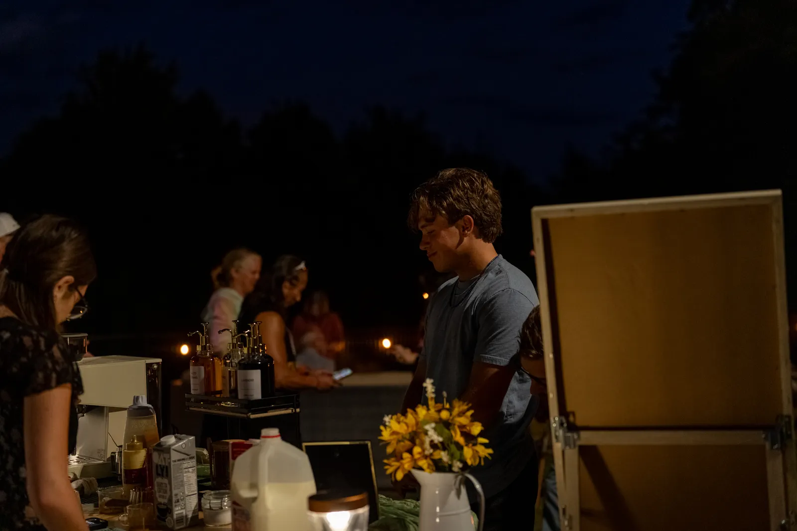 The cart at dusk with sunflowers on the counter and string lights strung across the yard.