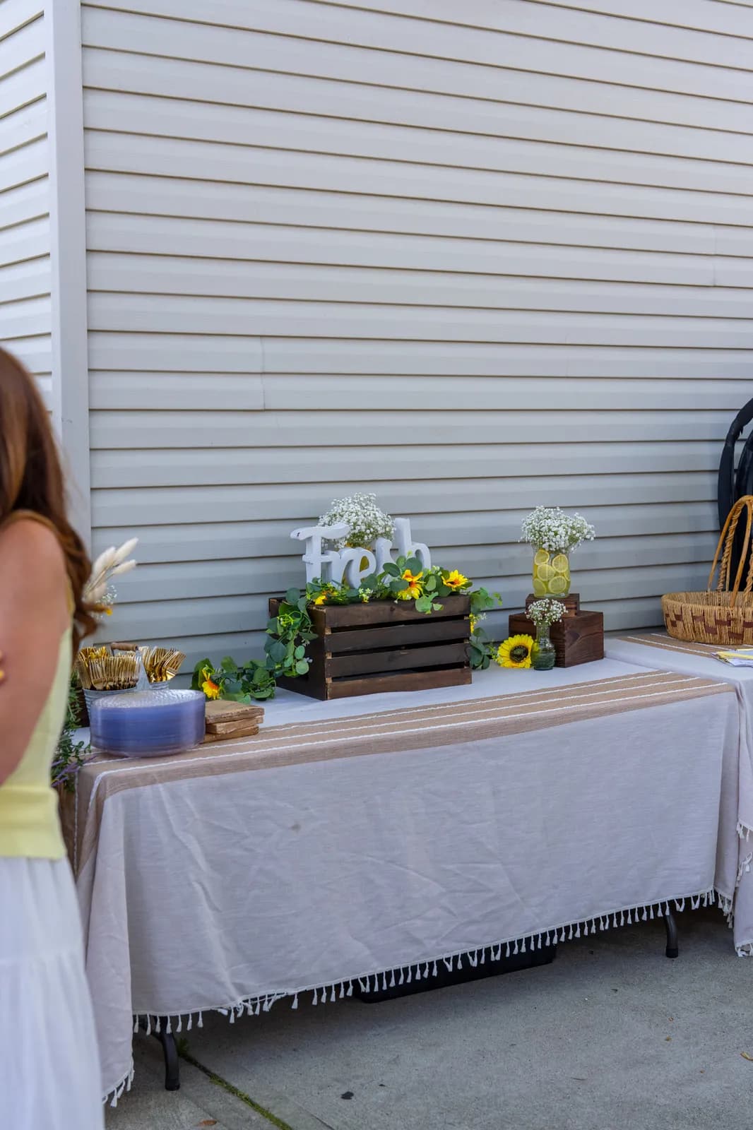 A guest lingers near the cart as the yard fills with warm ambient light.
